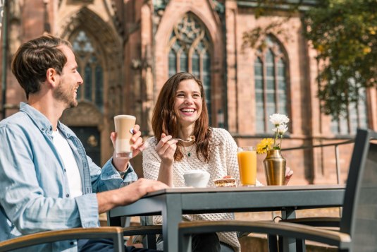 Ein Paar trinkt vor dem Dom in Worms