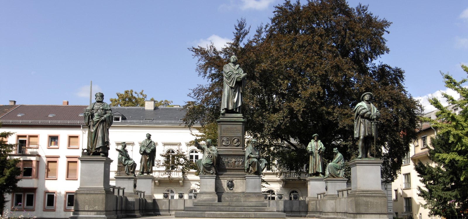 Auf dem Bild ist das Lutherdenkmal in Worms zu sehen. Die Skulptur stellt den Reformator Martin Luther dar, der vor dem Reichstag in Worms im Jahr 1521 seine ber&uuml;hmten Worte sprach: "Hier stehe ich, ich kann nicht anders. Gott helfe mir. Amen." Das Denkmal ist ein eindrucksvolles Zeugnis der historischen Ereignisse und ein bedeutender Ort in Worms.